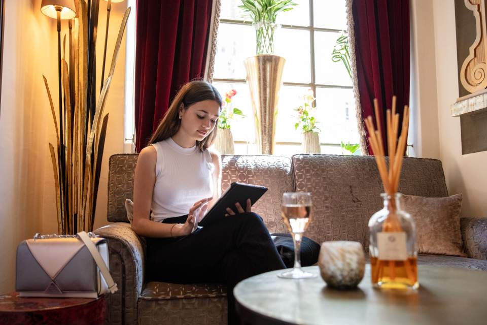 Woman having a drink in the bar of the hotel, Le Cavendish, 4 stars hotel in Cannes city Centre